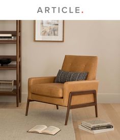 a brown chair sitting on top of a wooden floor next to a bookshelf