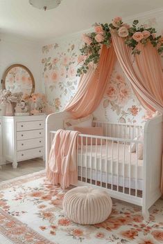 a baby's room with floral wallpaper and pink drapes over the crib