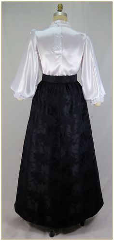 "Poly. Color: Black. Beautiful woven jacquard satin fabric in rose pattern design. Victorian style skirt cut in gore style for the silhouette of the period. Comfortable matching black elastic waistband. Total circumference approx. 94\"' at hemline. Machine washable. Circa 1890-1905. Made in U.S.A. Sizes: SM, MED, LG, XLG & 2XLG. Matching satin jacquard belt sold separately. Size Assistance for Elastic Waist Skirt: SM fits up to 26\" waist MED fits up to 32\" waist LG fits up to 38\" waist XL Middle Ages Clothing, Rose Pattern Design, Victorian Skirt, Corporate Goth, Jacquard Skirt, Old Fashion Dresses, Elastic Waist Skirt, Beauty Dress, Ootd Style