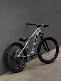 a bike leaning against a wall on the sidewalk