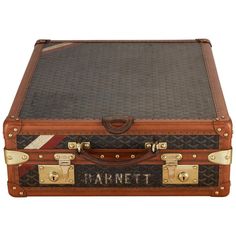 an old fashioned suitcase with the name harriet on it's side and handles in gold