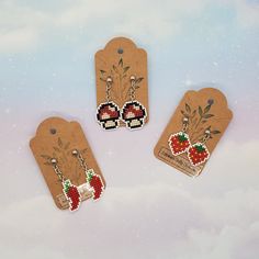 three small tags with designs on them