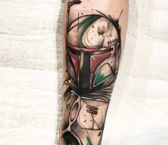 a tattoo on the arm of a person with a boba fett helmet in it