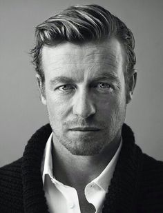 a black and white photo of a man wearing a sweater