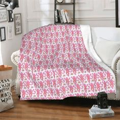 a couch with a pink and white blanket on it