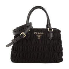 This Prada black tessuto gaufre nylon handbag is luxurious and practical. There are three interior compartments with a zip divider, which is great for organizing and separating your personal belongings. The nylon material is durable and looks sleek with the black saffiano leather trim. The gold Prada Paris logo also goes beautifully with the black nylon. This designer bag is great for everyday use and can also be carried by the handles or adjustable strap.    Model: 1BA173  Black tessuto gaufre Luxury Nylon Bag With Detachable Handle, Elegant Nylon Tote Bag, Elegant Top Handle Nylon Bags, Designer Nylon Top Handle Bag, Elegant Nylon Top Handle Bags, Designer Nylon Bag With Double Handle, Designer Nylon Bags With Double Handle, Elegant Nylon Shoulder Bag For Shopping, Luxury Nylon Shopping Bag