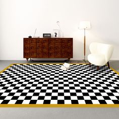 a black and white checkered area rug in a living room with a chair, dresser and lamp