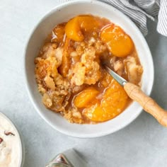 a bowl filled with food next to a cup of ice cream