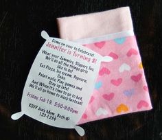 a pink and white baby blanket with hearts on it, next to a tag that says valentine's is turning 3