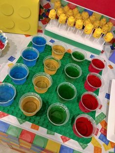 there are many different colors of paint on the lego trays and in each cup