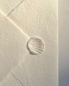 a white envelope with a seashell on it