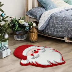 a bedroom decorated for christmas with a santa clause rug on the floor and a small tree