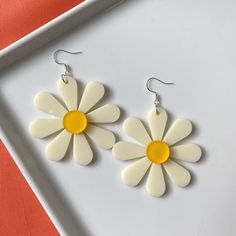 These earrings measure approximately 3 inches (7.6 cm) in length including hardware. Each flower is 2.2 inches (5.6 cm) in diameter.  The ear wires (sometimes called French hooks) are plated in sterling silver so they're great for sensitive ears. Sterling silver is also hypoallergenic and nickel-free.  As if that weren't enough, they're ALSO ultra lightweight, weighing about 6 grams each. Vintage White Flower Drop Earrings, Retro White Flower Jewelry, Retro Flower-shaped Jewelry For Summer, Retro Flower-shaped Earrings For Gift, Retro Spring Flower Earrings Gift, White Daisy Flower Earrings For Spring, Trendy Flower Earrings, Trendy Flower Shaped Earrings, Vintage Flower Earrings For Summer