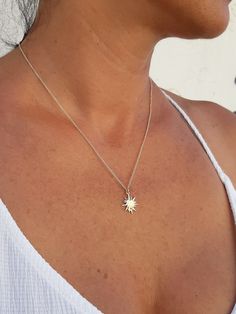 "White gold sun necklace - a dainty minimalist celestial sun necklace. This small sunshine necklace is a perfect solid gold jewelry piece to add a sparkling touch to your outfit. This white gold sun necklace with a starburst pendant would make a unique gift for a mom or a nature lover friend. The sun is a unified symbol across religions and cultures. It symbolizes the divine, birth, and healing. This unique sun necklace is delicate enough to wear as an everyday necklace, or as a stacked necklace Minimalist Sterling Silver Jewelry With Sun Design, Dainty Sun Design Jewelry For Everyday Wear, Dainty Sun And Moon Design Charm Necklaces For Everyday, Dainty Sun Design Jewelry For Everyday, Everyday Dainty Sun And Moon Charm Necklaces, Dainty Sun Design Necklace For Everyday, Dainty Everyday Necklaces With Sun Design, Dainty Sun And Moon Design Charm Necklaces, Dainty Everyday Sun Design Jewelry