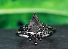 a black diamond ring sitting on top of a table