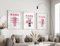 a living room with couches, chairs and pictures on the wall above them that say kaws