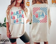 "Retro USA Comfort Colors Shirt, 4th Of July Tee, Retro Funny Fourth Shirt, Womens 4th of July Shirt, America Patriotic Tshirt, Independence HOW TO ORDER ➀ Select color ➁ Select the size (Please check size chart) ✦ True to size. Size up 1-2 sizes for an oversized look. ➂ Add to cart ✦ (Optional) \"Add message to Seller\" on the checkout page. GARMENT FEATURES ✦ Crew neckline ✦ Direct to garment printing - no vinyl, decal, or iron-on technique ✦ Our designs are printed on the garment to last a lo Retro Short Sleeve Tops For 4th Of July, Retro American Flag Print T-shirt For Summer, Fun Short Sleeve Independence Day Shirt, Fun Short Sleeve Shirt For Independence Day, Fun Graphic Print Tops For Independence Day, Independence Day Fun Short Sleeve Shirt, Retro Letter Print Tops For 4th Of July, Patriotic Screen Print Shirt For Summer, Graphic Print T-shirt For 4th Of July Birthday