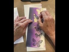 an older person is working on some butterflies