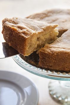 a close up of a cake on a plate with a fork and magazine cover in the background