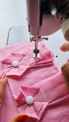 someone is using a sewing machine on a pink shirt