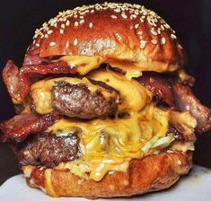 a cheeseburger with bacon and onions on a bun