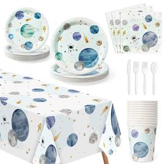 a table set with plates, napkins and utensils in space themed design