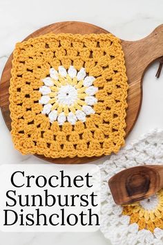 crochet sunburst dishcloth on a wooden cutting board