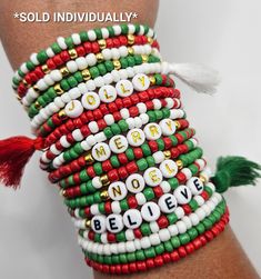 a close up of a person's wrist with beads and tassels on it