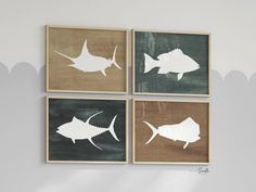 three framed pictures with white fish on them