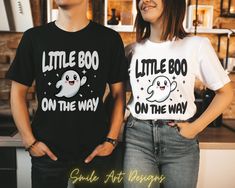 Get ready to reveal your pregnancy with our hilarious Halloween pregnancy announcement shirts! These funny tees blend spooky season with baby-on-the-way excitement, a perfect way for couples to share their boo-tiful news with a side of humor. Spread the laughter and announce your little Boo on the way in style with these spooky and maternity-approved Halloween tees! These T-shirts are UNISEX SIZING true to size, if you looking for oversized look size up. Check sizing in pictures for the best fit Pregnancy Reveal Halloween Costumes, Funny Black Tops For Gender Reveal, Cute Black T-shirt With Funny Text, Black Graphic Tee For Gender Reveal, Funny Letter Print T-shirt For Gender Reveal, Pregnancy Announcement Costume Halloween, Funny T-shirt For Gender Reveal With Letter Print, Funny T-shirt For Gender Reveal, Funny Crew Neck T-shirt For Gender Reveal