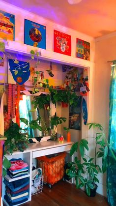 a room filled with lots of plants and pictures on the wall