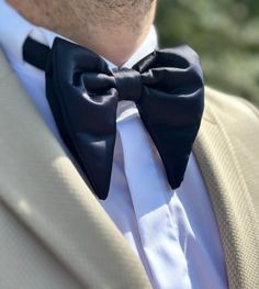 "Example Using Wedding as a Place: \"Imagine the grandeur of a majestic castle wedding, with you donning our navy, dark blue, and parlament blue butterfly bow tie. Its royal hues perfectly match the regal ambiance, making it the ideal accessory for a fairy tale wedding. Let your attire be as enchanting as the venue itself, creating timeless memories on your special day.\" 5 More Examples of Places and Weddings: 1- Beachfront Nuptials: Say \"I do\" by the sea, and let our elegant bow tie accentuate your beachfront wedding style. 2- Rustic Barn Wedding: Embrace the rustic charm of a barn wedding with our quality satin bow tie, a symbol of country elegance on your special day. 3- City Rooftop Wedding: For a modern and chic rooftop wedding, our butterfly bow tie adds a touch of sophistication Black Bow Tie For Wedding, Classic Wedding Suit And Tie Accessories With Satin Finish, Classic Black Suit And Tie Accessories For Wedding, Dapper Black Tuxedo For Wedding, Classic Black Wedding Suit And Tie Accessories, Black Tuxedo With Ties For Wedding, Tuxedo Wedding Accessories With Satin Bow, Classic Black Bow Tie For Groom, Dapper Bow With Butterfly Knot For Wedding