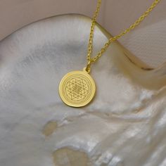 Unleash the Power of Sacred Geometry with Our 14K Solid Gold Sri Yantra Necklace Experience the divine energy of our meticulously crafted Sri Yantra Necklace, a symbol of cosmic harmony and meditation. Made from the finest 14K solid gold, this sacred geometry pendant is not just a piece of jewelry, but a tool for spiritual awakening and energy healing. Key Features: Material: Premium 14K Solid Gold Design: Intricate Sri Yantra symbol, representing the union of the divine and the material Pendant Spiritual Yellow Gold Pendant Temple Necklace, Round Amulet Necklaces For Puja, Gold Plated Spiritual Round Pendant, 22k Gold Spiritual Round Pendant Jewelry, Gold Pendant Necklace For Meditation, 22k Gold Spiritual Pendant Necklace, Power Of Meditation, Divine Energy, Sri Yantra