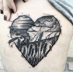 a woman's thigh with a heart - shaped tattoo on the side of her stomach