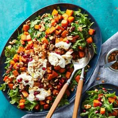 a plate filled with salad and dressing on top of a blue table