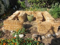 a large hay bale sitting in the middle of a garden