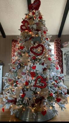 a white christmas tree with red and silver decorations