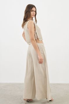 Looking for a genuine super soft and everyday top? Designed in a light silhouette, sleeveless Mia Side Ties Top can be worn with ease all summer long and compliments most body types with adjustable side-ties. - 100% Turkish double layered gauze cotton - Side slits tied with adjustable side-ties.- Crop top finish at waist Versatile Tank Top For Summer Loungewear, Relaxed Sleeveless Tank Top For Spring, Sleeveless Drawstring Tops For Loungewear, Sleeveless Tops With Drawstring Tie, Casual Sleeveless Tops With Tie Waist, Sleeveless Tie-waist Tops For Vacation, Sleeveless Beige Top With Tie Back, Beige Sleeveless Top With Tie Back, Sleeveless Top With Drawstring Tie For Vacation