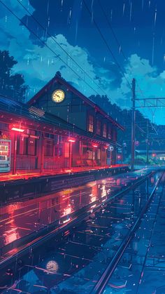 a train station in the rain at night