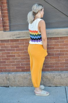 This rainbow crochet sweater tank top radiates joy and vibrancy, perfect for infusing your wardrobe with a playful pop of color. Crafted entirely from 100% acrylic, it offers a lightweight yet cozy feel, making it suitable for layering or wearing on its own. The crochet construction adds texture and visual interest, while the rainbow color palette brings a cheerful and whimsical touch to the piece. Whether you're lounging at a summer festival or enjoying a casual day out with friends, this tank Sleeveless Cotton Crochet Top For Fall, Multicolor Knit Sleeveless Tank Top, Spring Knit Sweater Vest For Loungewear, Multicolor Casual Tank Top For Loungewear, Casual Rainbow Sleeveless Top, Casual Multicolor Tank Top For Loungewear, Casual Multicolor Cotton Sweater Vest, Casual Orange Sleeveless Sweater Vest, Trendy Multicolor Cotton Knit Top