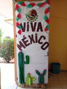 a sign that says viva mexico with cactus decorations on the front and side of it