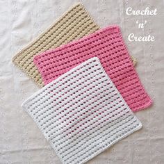 three crocheted napkins sitting on top of a white table covered in pink and beige