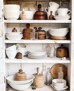 the shelves are filled with dishes and plates