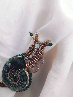 a close up of a piece of jewelry on a white cloth