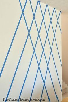 an empty room with blue lines painted on the wall