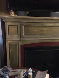 a cat is sitting on top of a fireplace