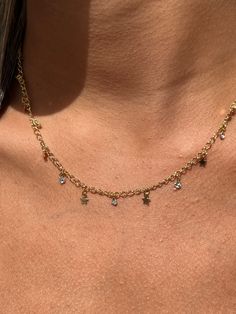 "Gold Filled Dangling Tiny Star Choker Necklace (Adjustable) Chain Length: 14\" with 2\" extension Clasp: Spring Ring  Finish: 18kt Gold Filled, Hypoallergenic, Will not tarnish Material: 18 Karat Gold Filled, Hypoallergenic. Tarnish Resistant. Gold-filled does not de-laminate or peel like Gold plated Jewelry nor does it tarnish as readily as silver. Generally speaking, gold filled is better quality and will have a much longer lasting color than plated jewelry. We recommend keeping abrasive chem Cheap Charm Necklaces With Delicate Chain Choker, Party Necklace With Star Charm Dangle, Party Dangle Necklaces With Star Charm, Party Star Necklace With Adjustable Chain, Party Star-shaped Necklace With Adjustable Chain, Star-shaped Charm Necklaces For Jewelry Making, Star-shaped Clavicle Chain Charm Necklace, Star Clavicle Chain Charm Necklace, Trendy Star-shaped Charm Necklace With Adjustable Chain