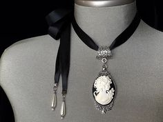 "Choker for Women! A raised and very intricate \"black and white\" cameo has been set in an antique silver pendant and attached to a quality, double sided black satin ribbon.... *Also available on an antique silver chain....please select the length you would prefer from the drop down menu The black satin ribbon measures approx. 48\" allowing for a sufficient bow... I have also added teardrop pearls to the end of each tie The perfect \"bridal accessory\" with a vintage theme.... The perfect birth Silver Cameo Jewelry For Party, Black Cameo Jewelry As A Gift, Vintage Cameo Jewelry For Party, Formal Adjustable Cameo Jewelry, Victorian Cameo Jewelry For Party, Black Cameo Jewelry For Gifts, Party Silver Cameo Jewelry, Victorian Style Adjustable Cameo Jewelry, Victorian Style Adjustable Silver Choker