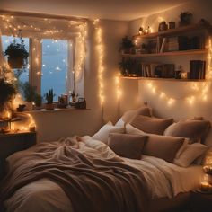 a bedroom with lights on the wall and a bed in front of a large window