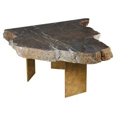 a table that has some kind of rock on it's side and is made out of metal